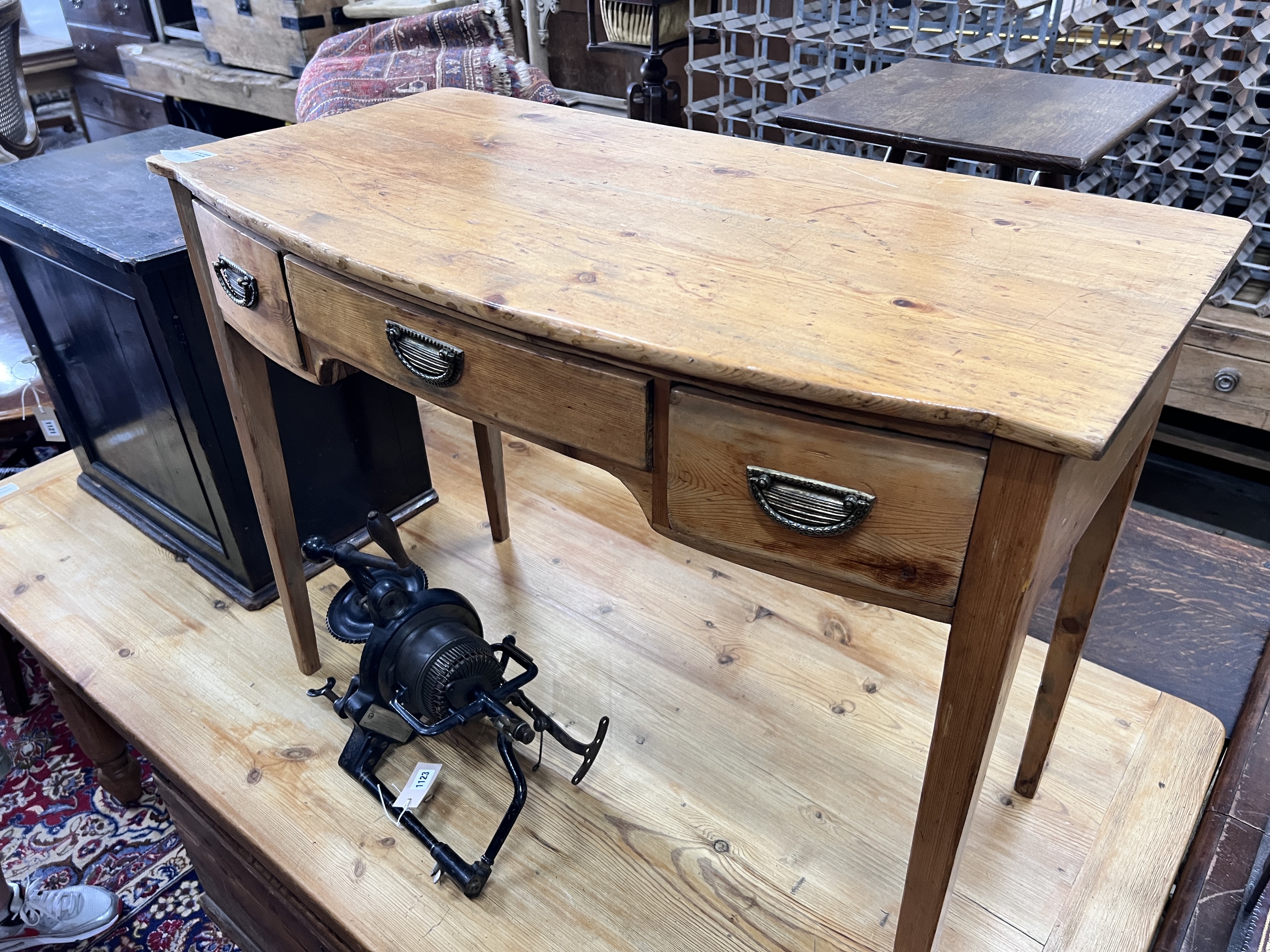 An early 19th century pine bow front three drawer side table, width 97cm, depth 50cm, height 73cm